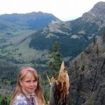 Girl Beside Broken Stump- hiking trips in Yellowstone