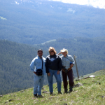 Three People Posing at Top of Mountain - Yellowstone Vacations